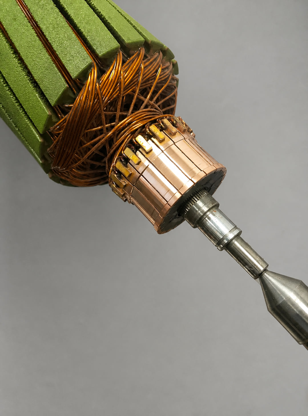 Close-up of a freshly machined AutoStore motor commutator showing bright copper segments with clean undercut insulation between them
