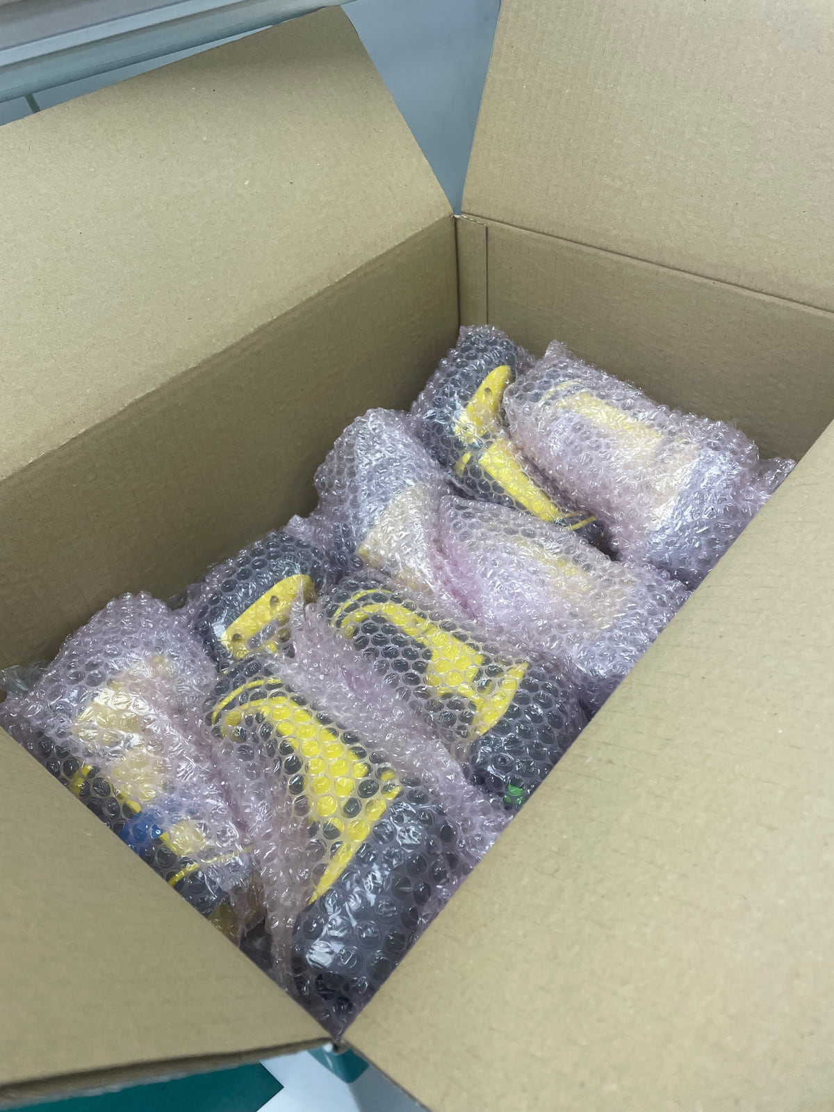 Refurbished industrial barcode scanners individually bubble-wrapped and boxed, ready to be returned to site