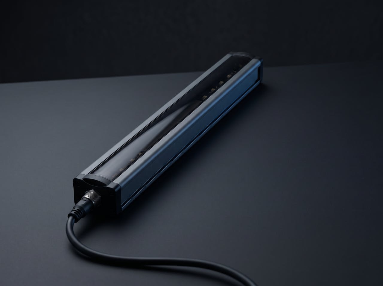 A safety light curtain emitter bar with its connection lead