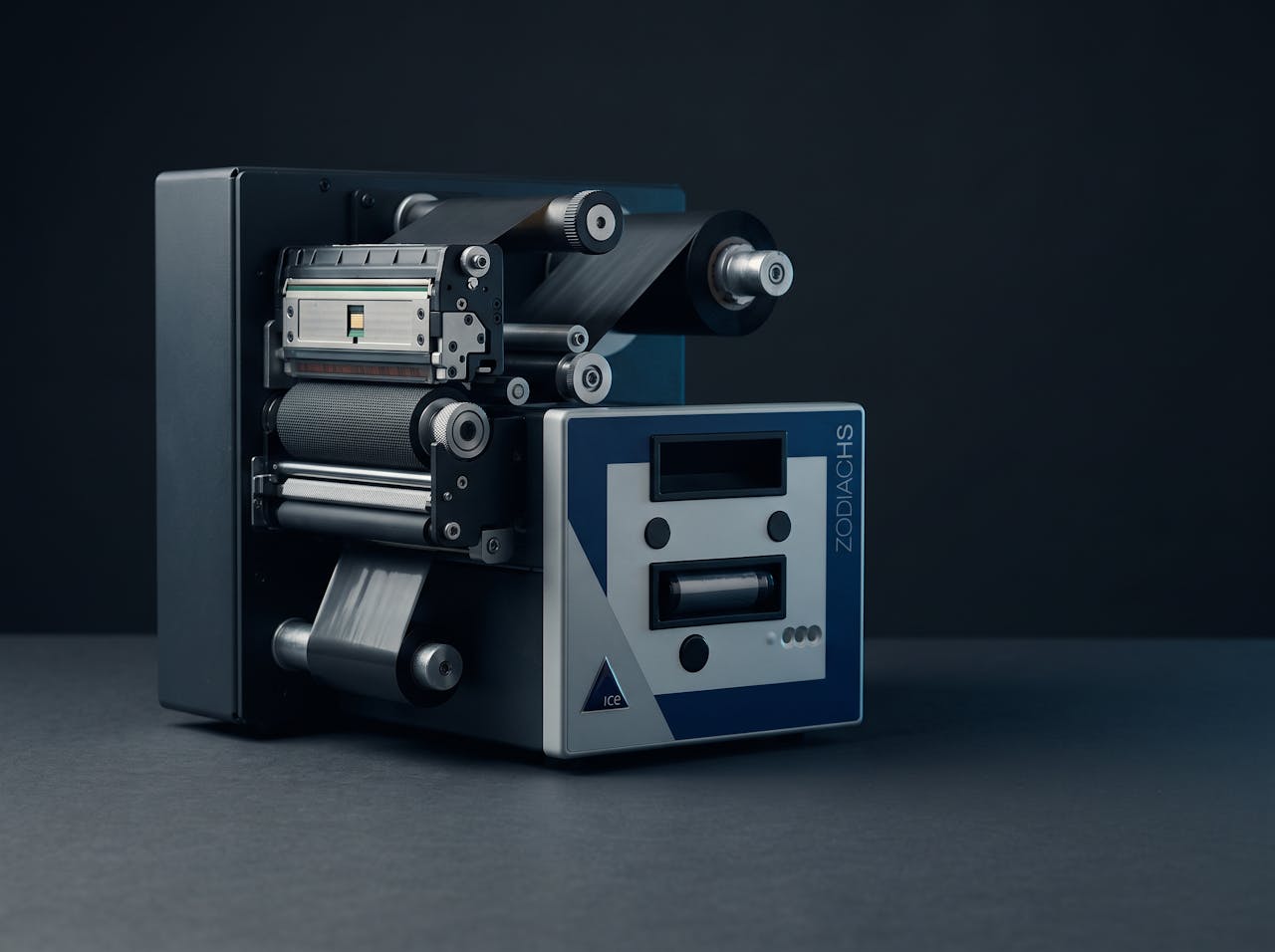 The print engine of a thermal transfer label printer, ribbon path and rollers exposed